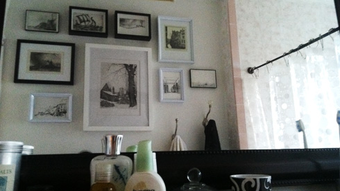 menagerie of pictures on bathroom wall