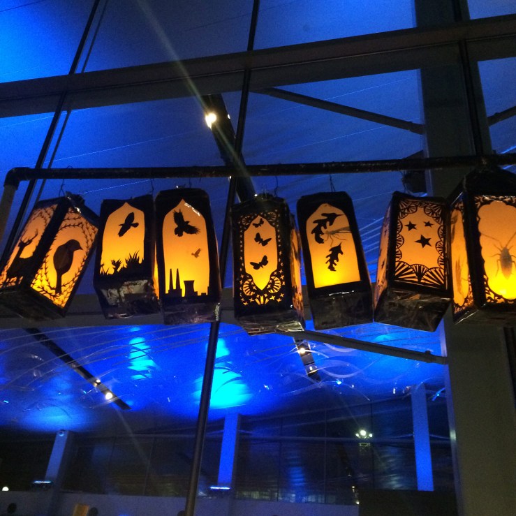 Lanterns above illuminated hand-cranked animation machine by Elizabeth Whitmore Crankie