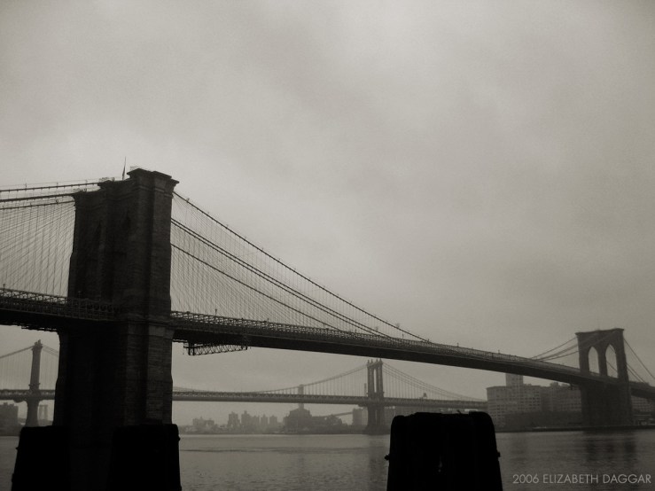 b&w photo pf brookly nbridge, manhattan bridge in distance
