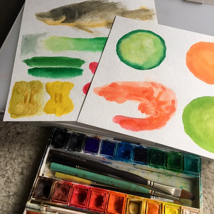 photo of desktop showing drawings, paint, and paintings