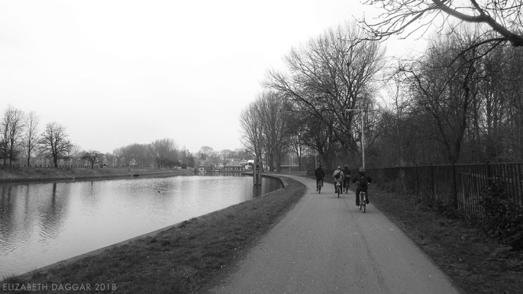 B&W photo of my cycling buddies on a waterside cycle path